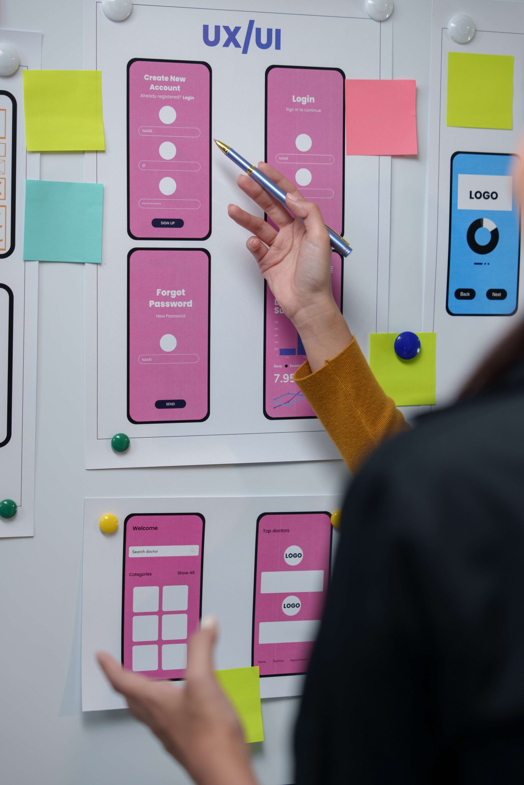 UX designers reviewing app wireframes and interface design